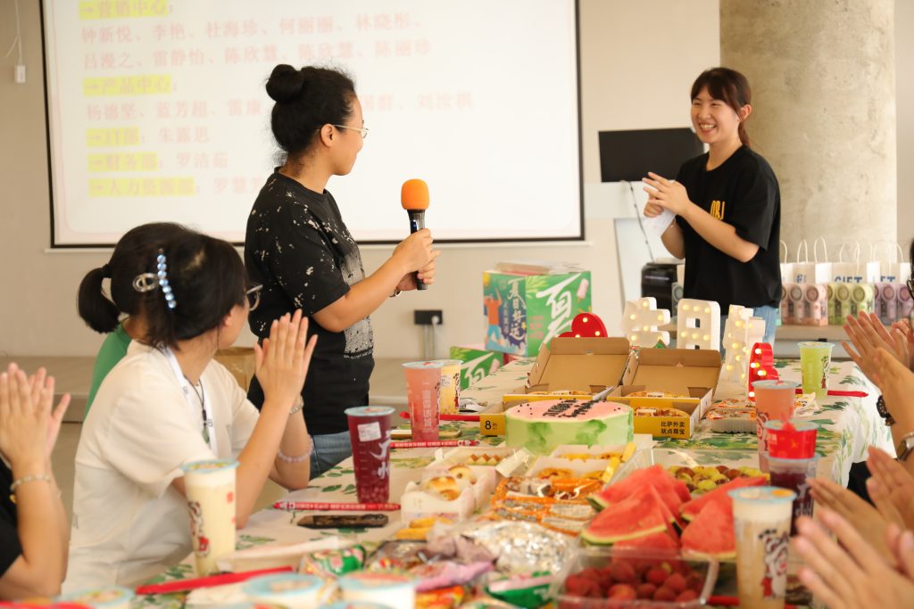 Employee Hosting an Activity at D&J Fashion’s Birthday Celebration D&J Fashion employee hosting a birthday activity during the July celebration.
