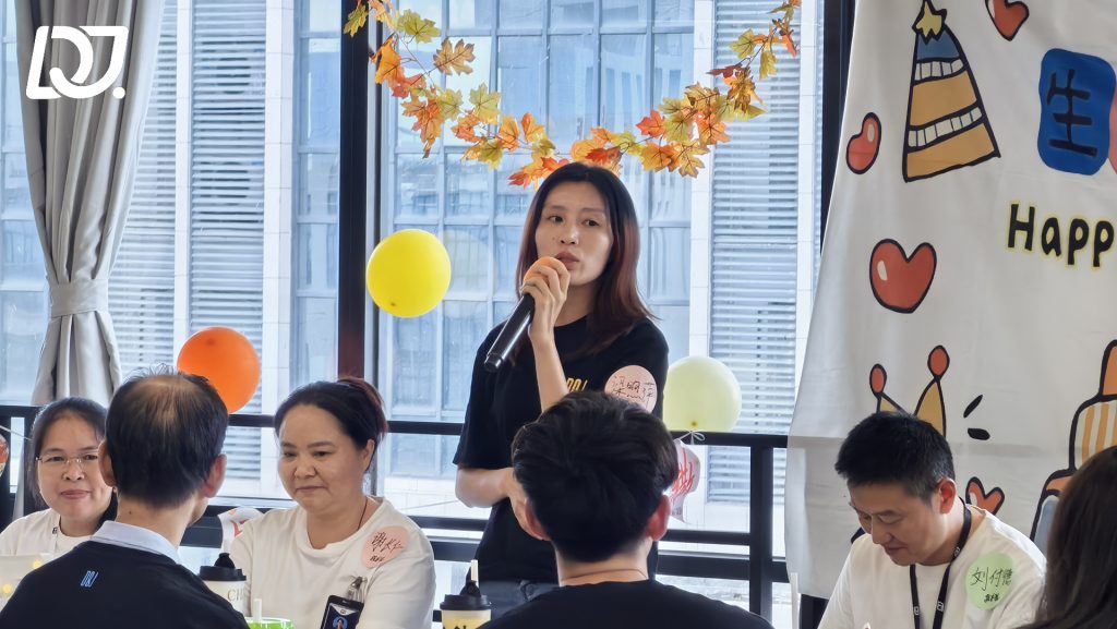 D&J Fashion Group employee giving a speech during the September birthday celebration, reflecting employee appreciation culture