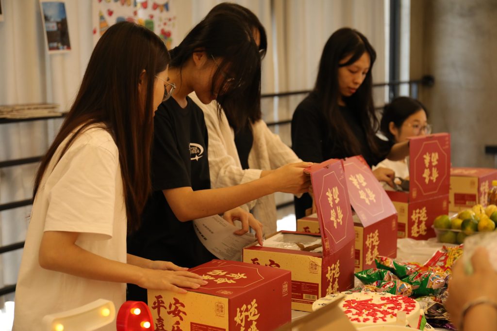Meaningful Gifts for Meaningful People at D&J Fashion Employees at D&J Fashion open curated gift boxes during the monthly birthday event.