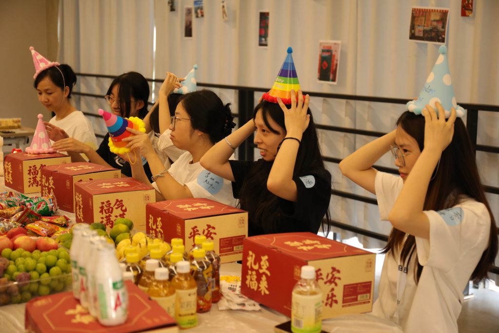 Getting the Party Started at D&J Fashion Team members at D&J Fashion putting on colorful party hats, ready for the birthday celebration to begin.
