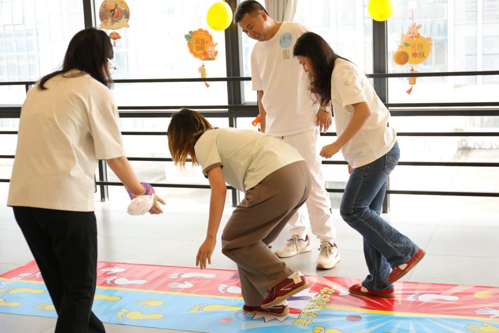 Employee Participation in D&J Fashion’s Mid-Autumn Festival D&J Fashion employee playing a game during the Mid-Autumn Festival