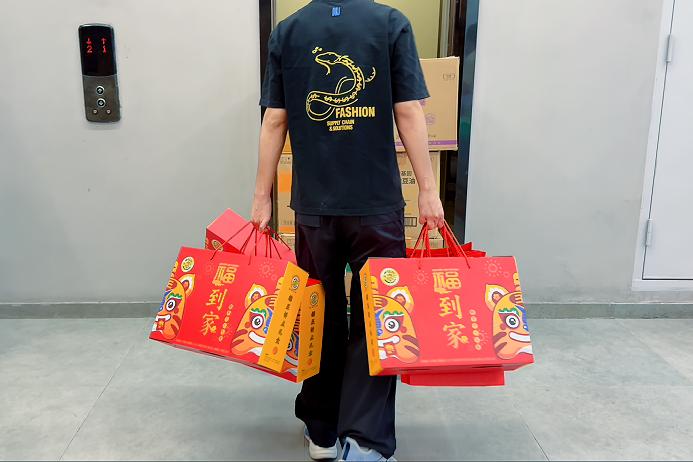 D&J Fashion employee receiving a Mid-Autumn Festival gift bag