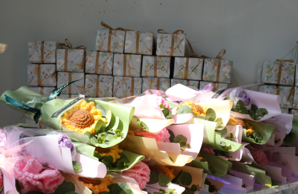 Rows of handmade flower bouquets and wrapped gift boxes prepared for Women’s Day inside a women’s clothing factory, highlighting people-first company culture, corporate responsibility, and employee well-being at an apparel export China business and eco-friendly OEM ODM supplier.